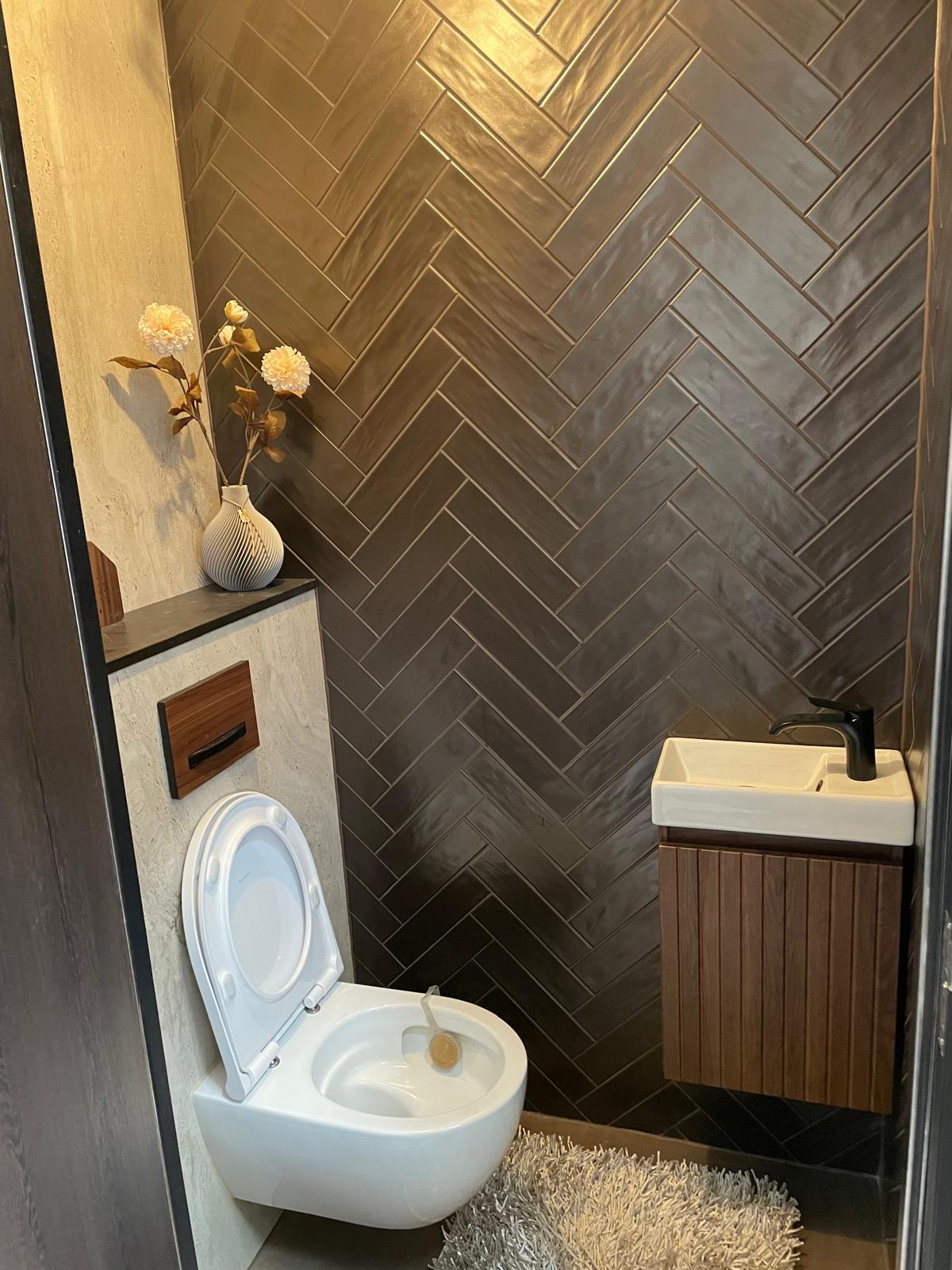 Finished bathroom renovation with modern tiling and fixtures